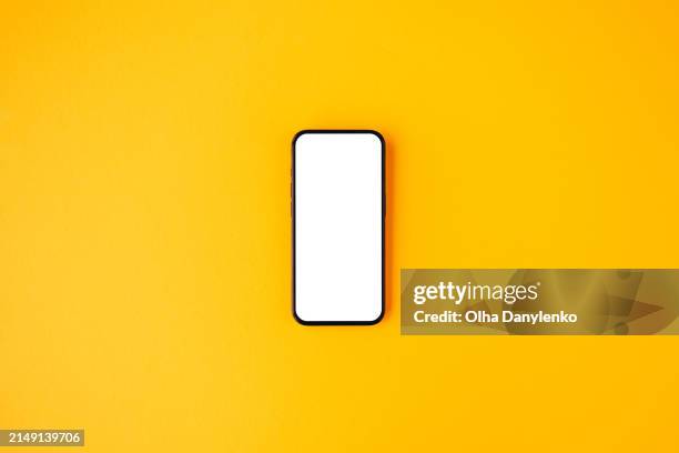 smartphone mockup on bright yellow background - sfondo giallo foto e immagini stock