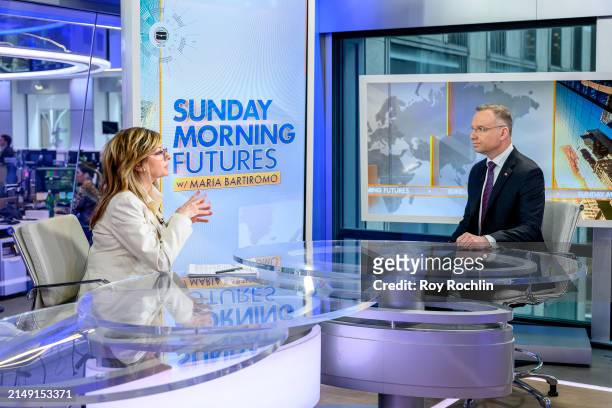 Host Maria Bartiromo with President of Poland Andrezej Duda as he visits "Sunday Morning Futures" at Fox News Channel Studios on April 18, 2024 in...
