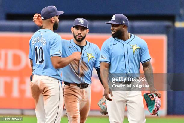 Amed Rosario, José Caballero, and Randy Arozarena of the Tampa Bay Rays celebrate after defeating the Los Angeles Angels 2-1 at Tropicana Field on...