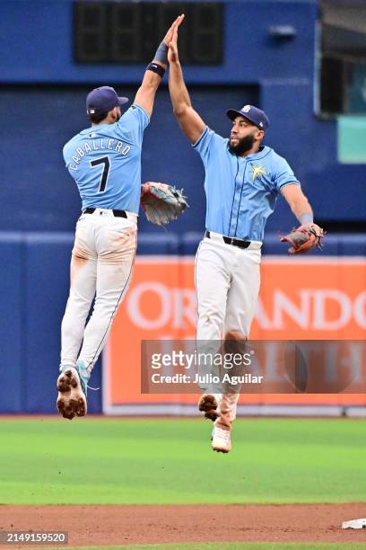 José Caballero and Amed Rosario of the Tampa Bay Rays celebrate after defeating the Los Angeles Angels 2-1 at Tropicana Field on April 18, 2024 in St...