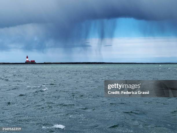 lighthouse under the rain on staple island, farne islands, north sea - north stock pictures, royalty-free photos & images