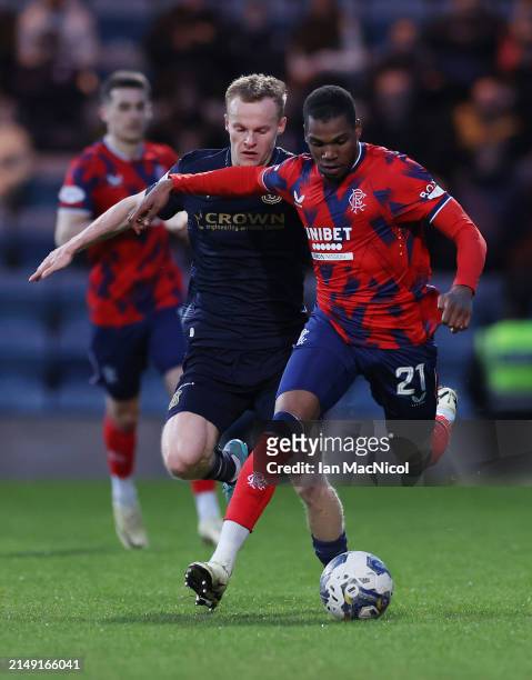 Scott Tiffoney of Dundee vies with Dujon Sterling of Rangers during the Cinch Scottish Premiership match between Dundee FC and Rangers FC at Dens...