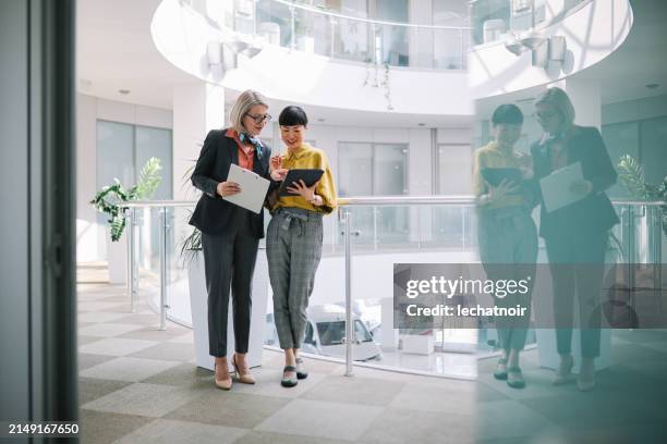 teamwork in corporate office environment - business occupation stock pictures, royalty-free photos & images
