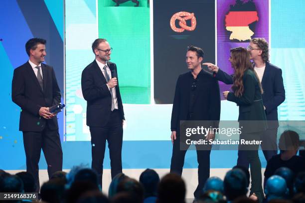 Hosts Uke Bosse, Katrin Bauernfeind and Studio "ROCKFISH Games" with "EVERSPACE 2", winner of the "Best German Game" award, speak on stage during the...