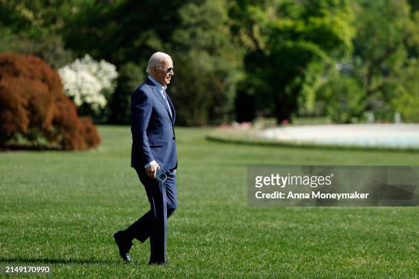 President Joe Biden walks on the South Lawn after landing on Marine One with senior members of his staff at the White House on April 18, 2024 in...