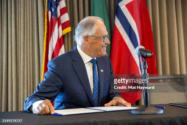 Washington Governor Jay Inslee prepares to sign a joint statement with Norway on climate action, maritime commerce, offshore wind, space technology,...