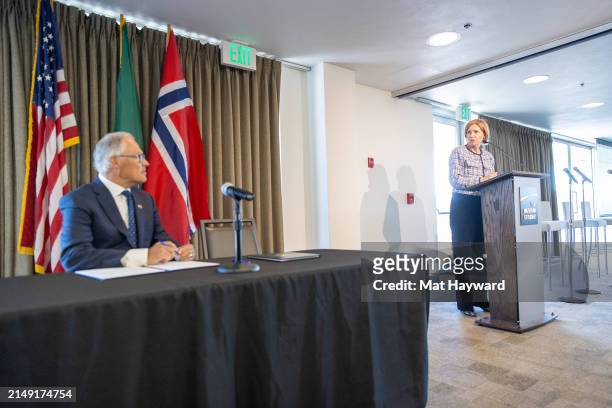 Washington Governor Jay Inslee listens to Norway's ambassador to the United States Anniken Krutnes before signing a joint statement on climate...