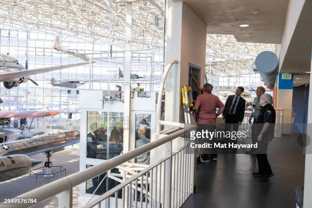 Maintenance workers attempt to fix a stalled elevator with Crown Prince Haakon of Norway inside at the Museum of Flight on April 18, 2024 in Tukwila,...