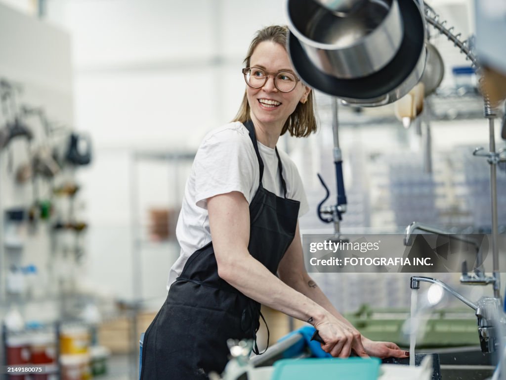 One female chocolatier working at the chocolate factory