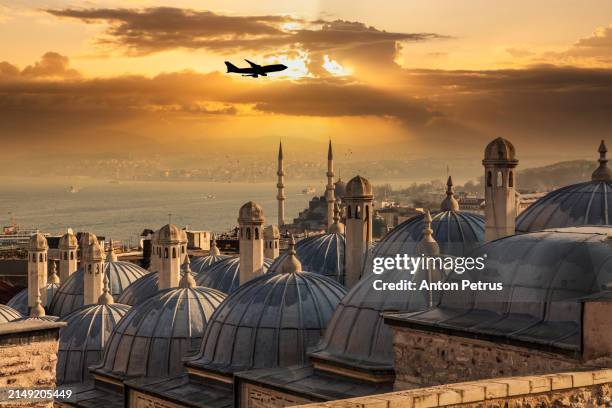 airplane over sunset view of istanbul. turkey - istanbul mosque stock pictures, royalty-free photos & images