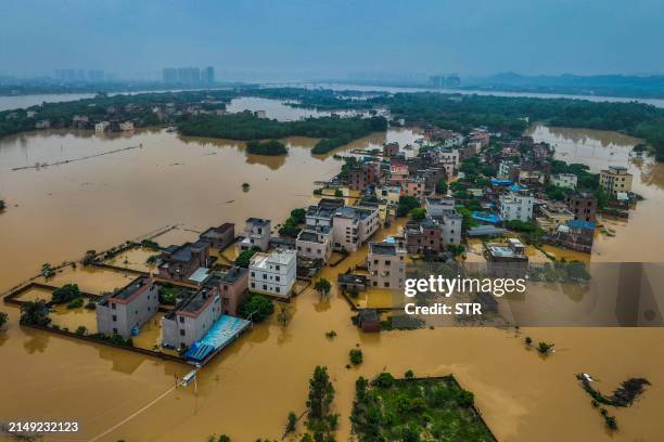 This aerial photograph taken on April 22, 2024 shows flooded buildings and streets after heavy rains in Qingyuan, in southern China's Guangdong...