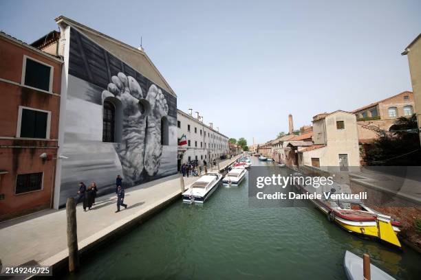 Mural by artist Maurizio Cattelan is seen outside Giudecca Women's Prison hosting the Holy See pavilion during the 60th Biennale Art 2024 on April...