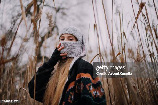 portrait of young woman in crocheted hat outdoors - fingerless glove stock pictures, royalty-free photos & images