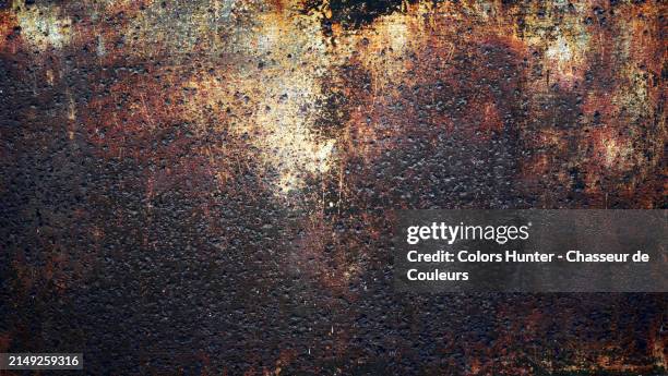 layers of paints scratched and weathered on a rusty and textured metal plate. photograph taken on a construction site in paris, france.
sunlight. natural colors. - burnt stock pictures, royalty-free photos & images