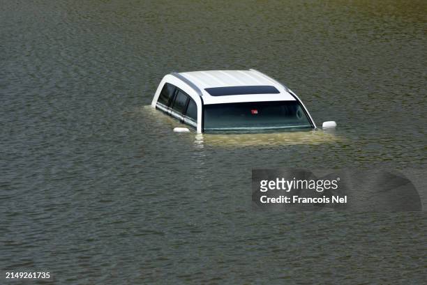 An abandoned vehicle lies in floodwater on April 19, 2024 in Dubai, United Arab Emirates. Atypically heavy rains in the UAE on Monday and Tuesday...