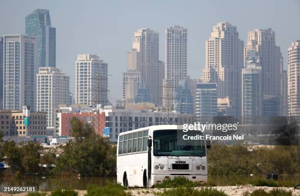 An abandoned bus is seen after flooding on April 19, 2024 in Dubai, United Arab Emirates. Atypically heavy rains in the UAE on Monday and Tuesday...