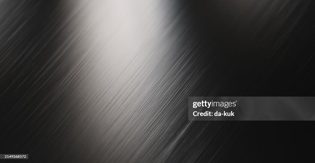 Futuristische metallische Oberfläche, die das Licht reflektiert. Abstrakter strukturierter Hintergrund