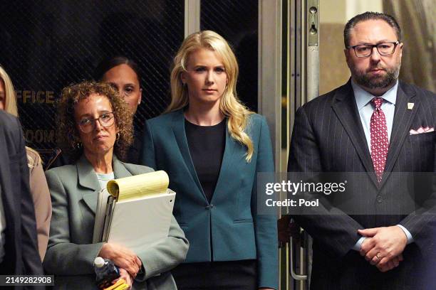 Attorney Susan Necheles, Communications aide Natalie Harp, and Trump advisor Jason Miller watch as former U.S. President Donald Trump speaks to the...