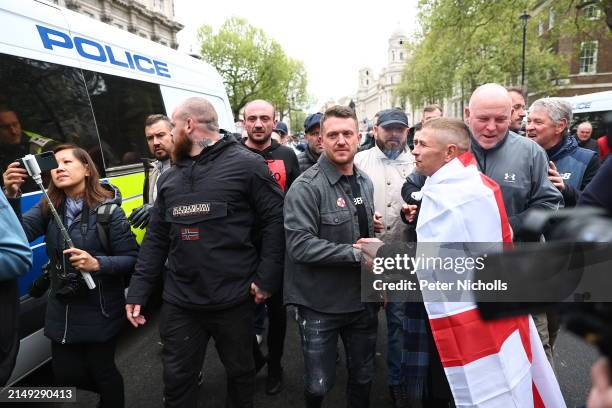 Far right activist Tommy Robinson is greeted as he attends a demonstration at Richmond Terrace, Whitehall on April 23, 2024 in London, England....