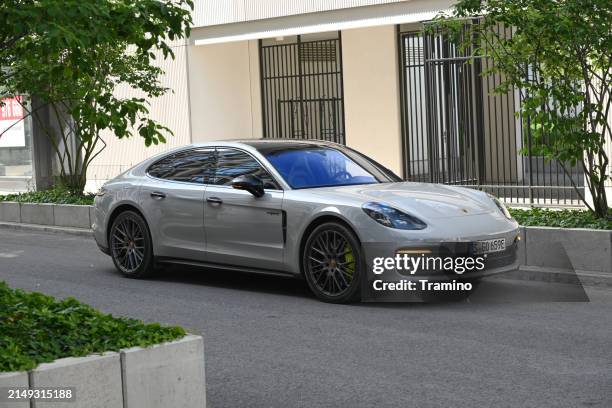 porsche panamera 4s e-hybrid on a street - porsche panamera stock pictures, royalty-free photos & images
