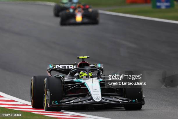 Lewis Hamilton of Great Britain driving the Mercedes AMG Petronas F1 Team W15 leads Max Verstappen of the Netherlands driving the Oracle Red Bull...