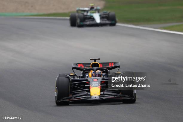 Max Verstappen of the Netherlands driving the Oracle Red Bull Racing RB20 leads Lewis Hamilton of Great Britain driving the Mercedes AMG Petronas F1...