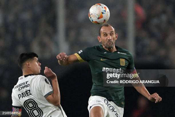 Colo-Colo's midfielder Esteban Pavez and Alianza Lima's Argentine forward Hernan Barcos fight for the ball during the Copa Libertadores group stage...