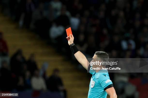 Referee Istvan Kovacs of Romania gives a red card to coach of FC Barcelona Xavi Hernandez during the UEFA Champions League quarter-final second leg...