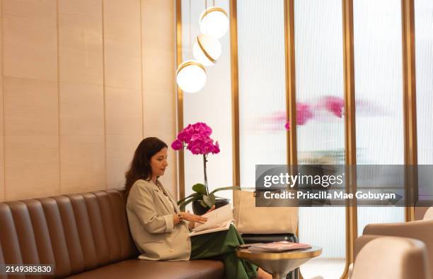 beautiful woman: reading a magazine - samsonite luggage stock pictures, royalty-free photos & images