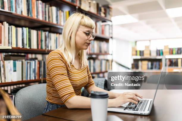 university student engages with laptop - online library stock pictures, royalty-free photos & images
