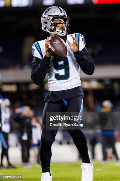 Bryce Young of the Carolina Panthers looks to throw a pass during pregame warmups before an NFL football game against the Chicago Bears at Soldier...