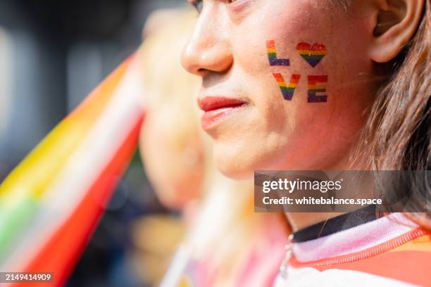 lgbtq+ friends enjoying the pride month parade - gay pride parade stock pictures, royalty-free photos & images