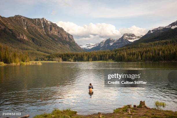 a young woman recreating at a mountain lake in montana - bozeman stock pictures, royalty-free photos & images