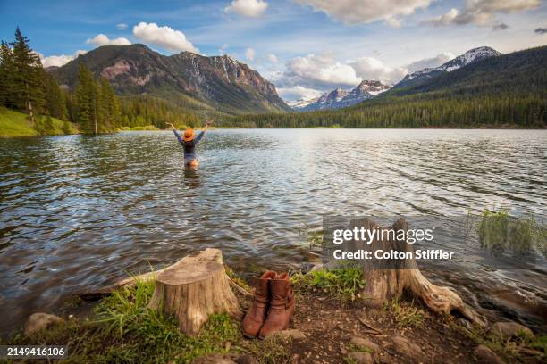 a young woman recreating at a mountain lake in montana - bozeman stock pictures, royalty-free photos & images