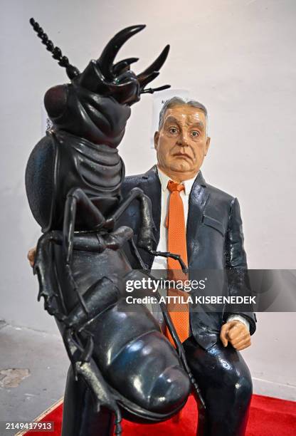 Sculpture of Hungarian Prime Minister Viktor Orban sitting on an ornate chair with a cockroach on his lap is seen in a central Budapest gallery on...