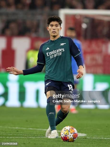 Takehiro Tomiyasu of FC Arsenal runs with a ball during the UEFA Champions League quarter-final second leg match between FC Bayern München and...