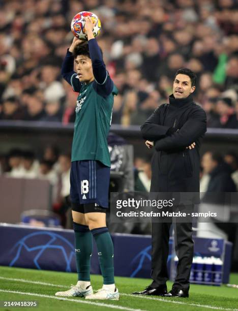 Takehiro Tomiyasu of FC Arsenal with Mikel Arteta head coach of FC Arsenal during the UEFA Champions League quarter-final second leg match between FC...