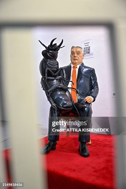 Sculpture of Hungarian Prime Minister Viktor Orban sitting on an ornate chair with a cockroach on his lap is seen in a central Budapest gallery on...