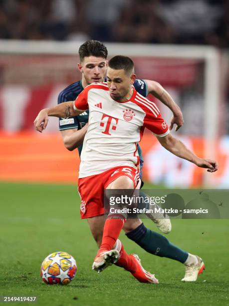Raphael Guerreiro of Bayern Muenchen vies with Declan Rice of FC Arsenal during the UEFA Champions League quarter-final second leg match between FC...