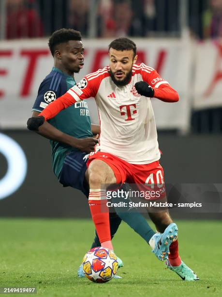 Noussair Mazraoui of FC Bayern Muenchen vies with ar0 during the UEFA Champions League quarter-final second leg match between FC Bayern München and...