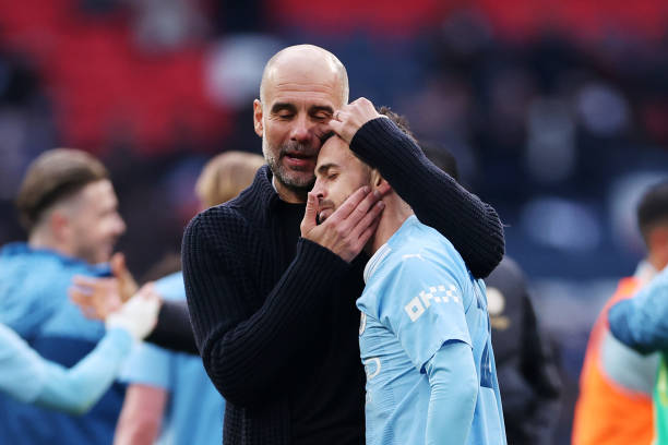 Pep Guardiola and Bernardo Silva of Manchester City celebrate after the team's victory during the Emirates FA Cup Semi Final match between Manchester...