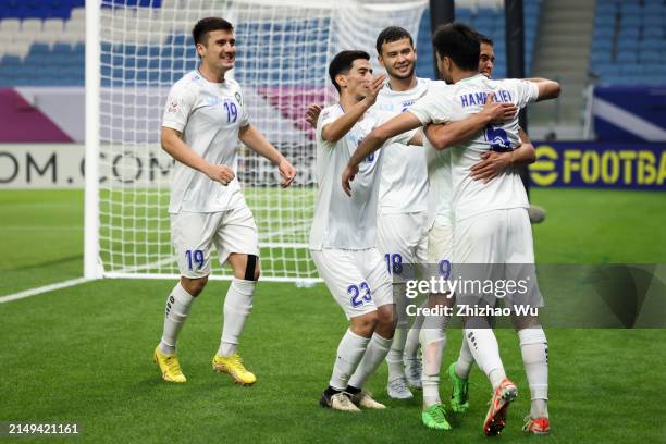 Muhammadkodir Hamraliev of Uzbekistan celebrates team's second goal with teammates during the AFC U23 Asian Cup Group D match between Kuwait and...