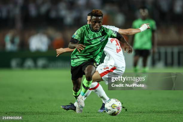 Mohamed Shehata of Zamalek is battling for the ball with Abdul Aziz Issah of Dreams during the CAF Confederations Cup knockout stage semifinal match...