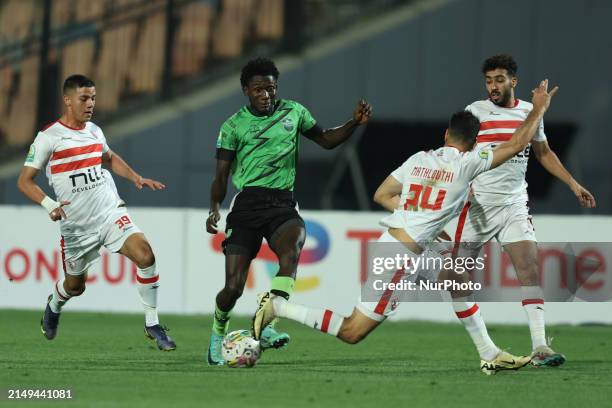 Hamza Mathlouthi and Mohamed Shehata of Zamalek are battling for the ball with Emmanuel Agyei of Dreams during the CAF Confederations Cup knockout...