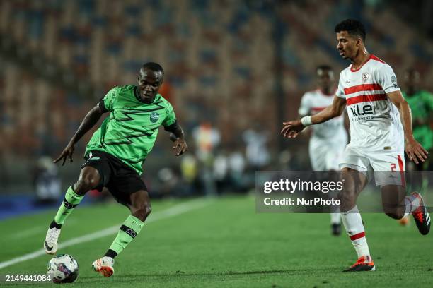 Hossam Abdelmaguid of Zamalek is battling for the ball with John Antwi of Dreams during the CAF Confederations Cup knockout stage semifinal match...