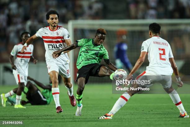 Ahmed Hamdi and Hossam Abdelmaguid of Zamalek are battling for the ball with Abdul Aziz Issah of Dreams during the CAF Confederations Cup knockout...