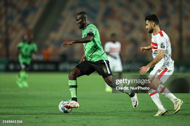 Hamza Mathlouthi of Zamalek is battling for the ball with John Antwi of Dreams during the CAF Confederations Cup knockout stage semifinal match...