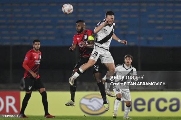 Athletico Paranaense's midfielder Alex Santana and Danubio's midfielder Santiago Romero fight for the ball during the Copa Sudamericana group stage...
