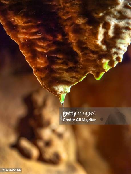 water drop from geological formation - höhlenforscher stock-fotos und bilder
