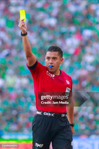 Victor Alfonso Caceres, central referee, shows a yellow card during the 16th round match between Leon and Monterrey as part of the Torneo Clausura...